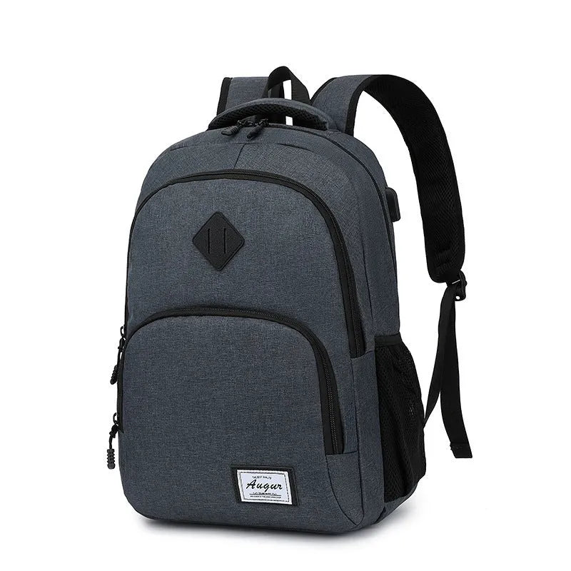 Grey lightweight nylon backpack with USB charging port shown on a trolley suitcase.