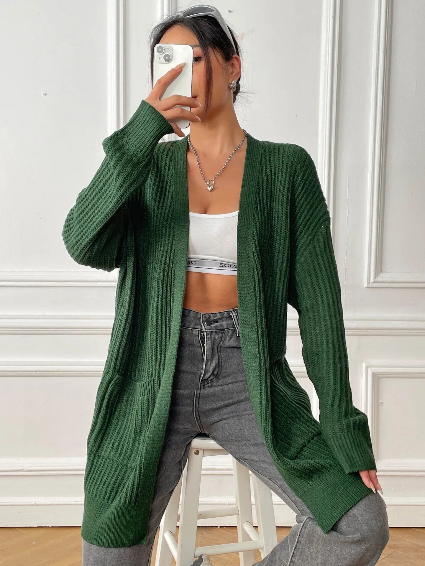 Womens double pocket acrylic cardigan in dark green colour showing mid-length design and loose fit