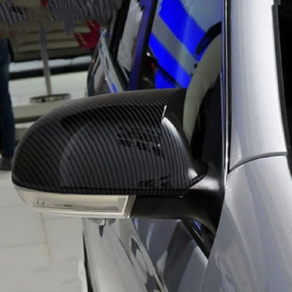 Pair of horn bright black plastic reflector shells for Volkswagen Sagitar side mirrors.
