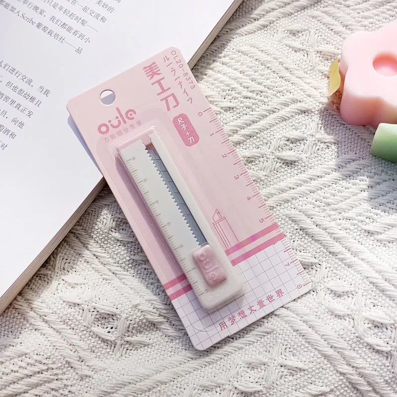 Mini portable art knife with plastic blade in five colour options showing 7.2cm length