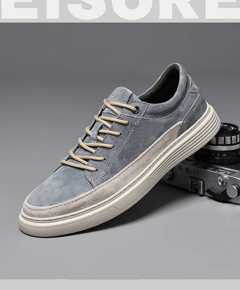 Grey and sand coloured low-top casual skate shoes with pigskin leather upper and rubber sole.