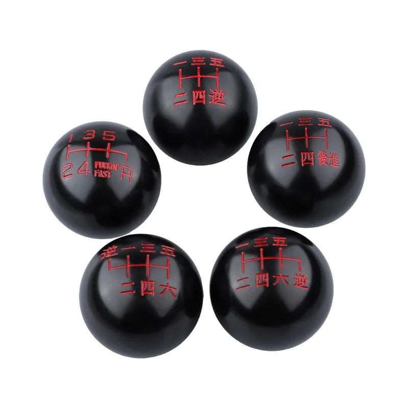 Round aluminium alloy car gear shift head shown in one of five available colour finishes.