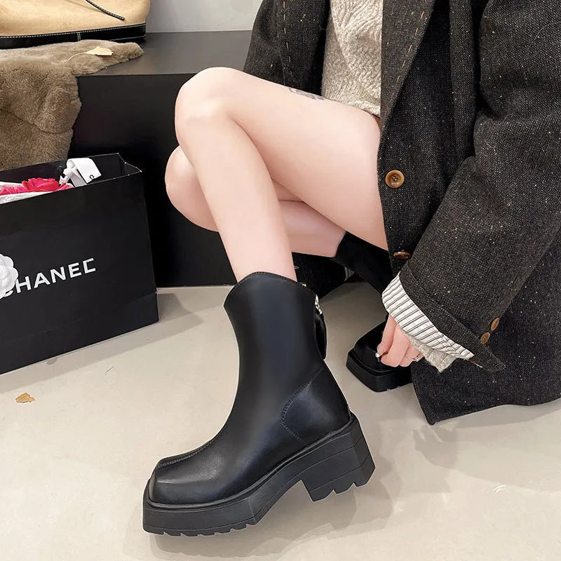 Black square toe platform Martin boots for women with a back zipper and mid-calf shaft.