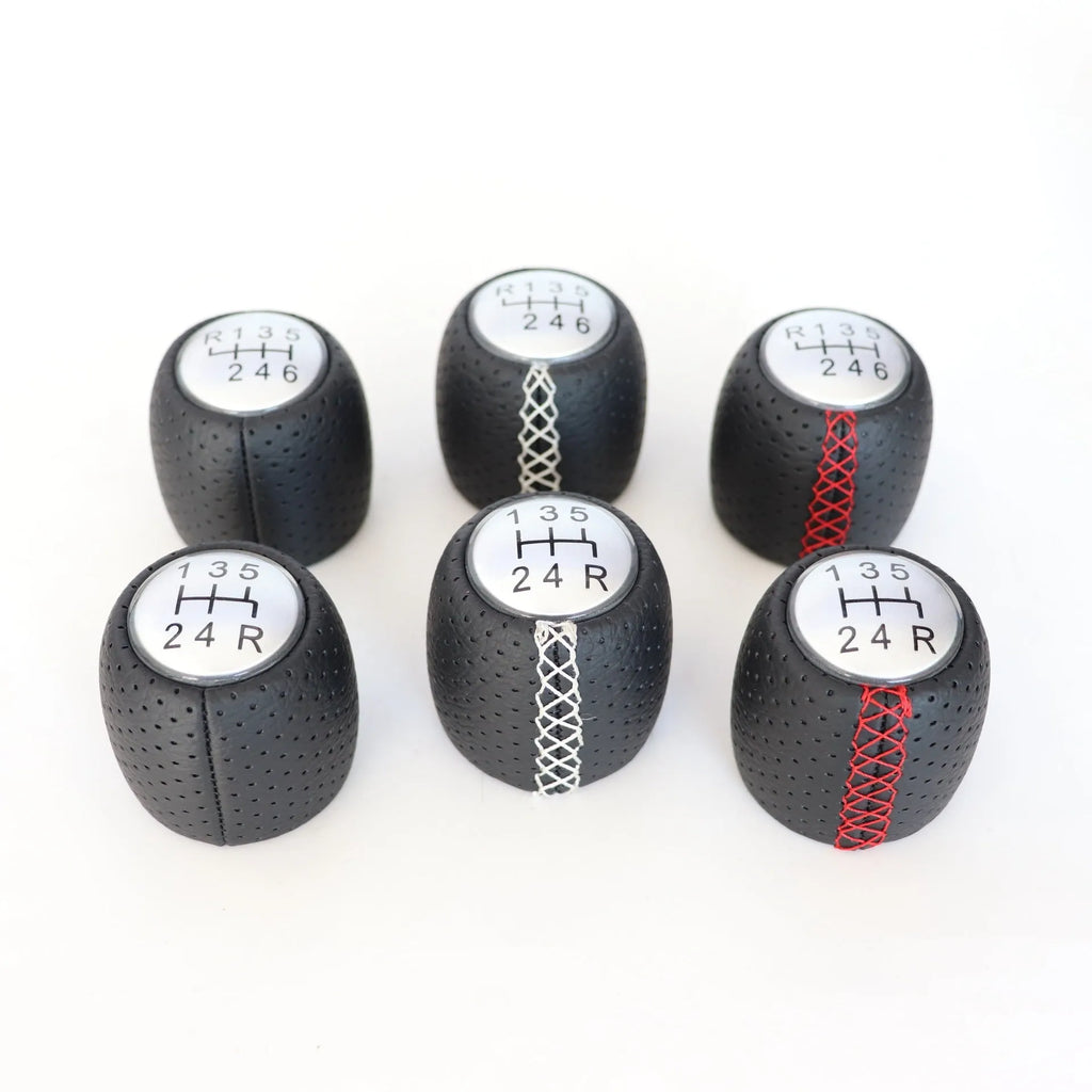 Black perforated leather-style gear shift knob for Alpha car on a 5-speed pattern matte cover.