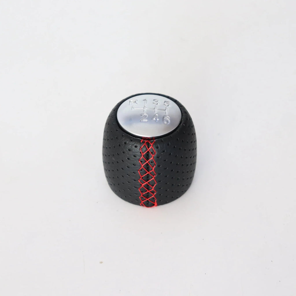 Black perforated leather-style gear shift knob for Alpha car on a 5-speed pattern matte cover.