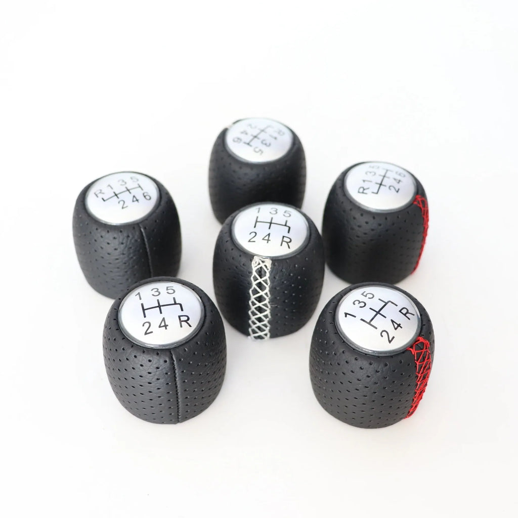 Black perforated leather-style gear shift knob for Alpha car on a 5-speed pattern matte cover.