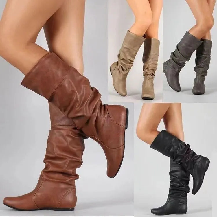 Women's black flat-heel slip-on ankle boots with round toe and high shaft on a rubber sole.