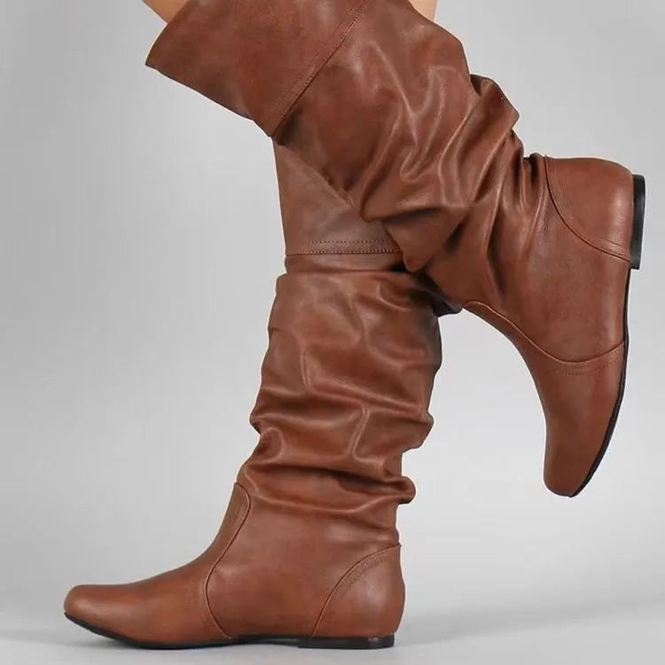 Women's black flat-heel slip-on ankle boots with round toe and high shaft on a rubber sole.