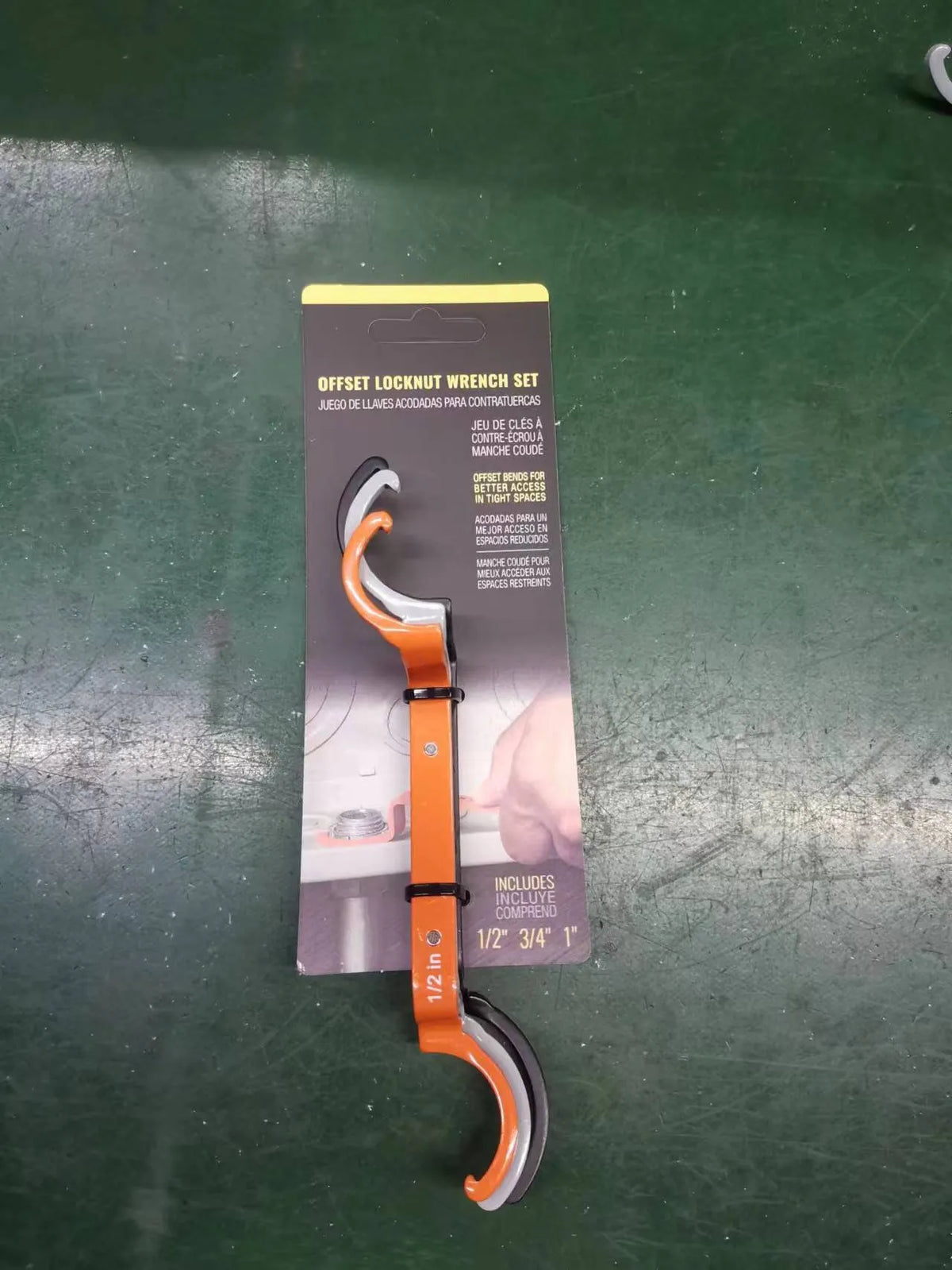 Orange, grey, and black crescent wrenches from a three-piece magnetic suction set for catheter locking.