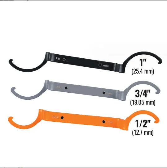 Orange, grey, and black crescent wrenches from a three-piece magnetic suction set for catheter locking.