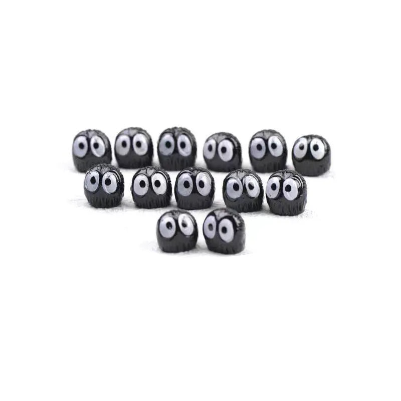 Small black cartoon-shaped resin briquette decorations for car interiors with traceless tape.