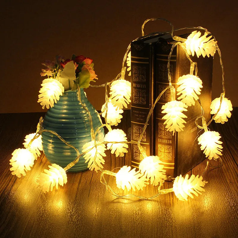 Warm white LED pine cone decorative light string powered by two AA batteries.