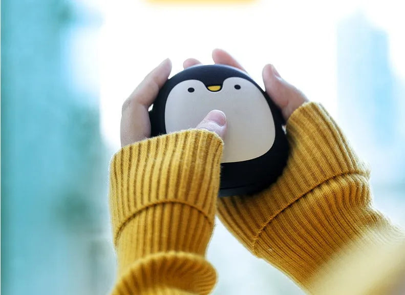 USB rechargeable electric hand warmer with penguin polar bear design showing front and back heating surfaces