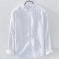 Man's loose fitting long sleeve linen shirt in a solid colour on a hanger.