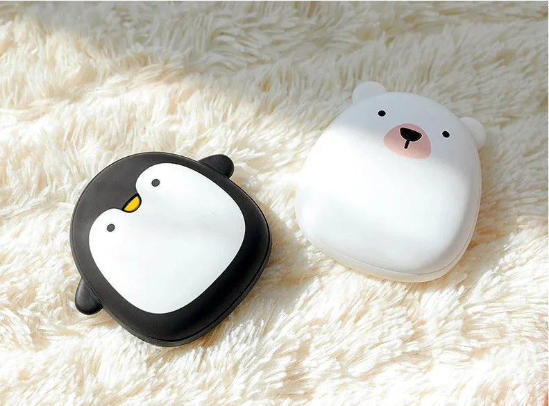 USB rechargeable electric hand warmer with penguin polar bear design showing front and back heating surfaces