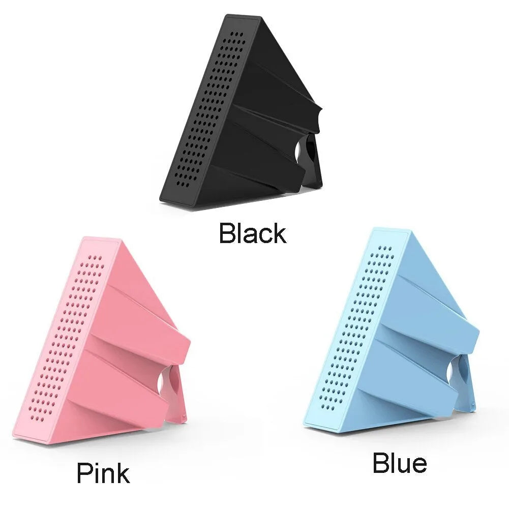 Pink portable ABS mobile phone amplifier bracket holding a smartphone horizontally on a desk.