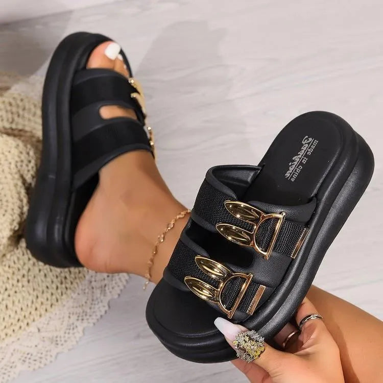 Women's apricot suede slippers with a thick, soft rubber sole on a wooden floor.