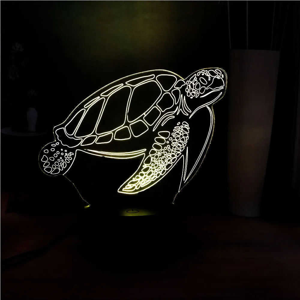 3D acrylic turtle-shaped LED night light with remote control on a table
