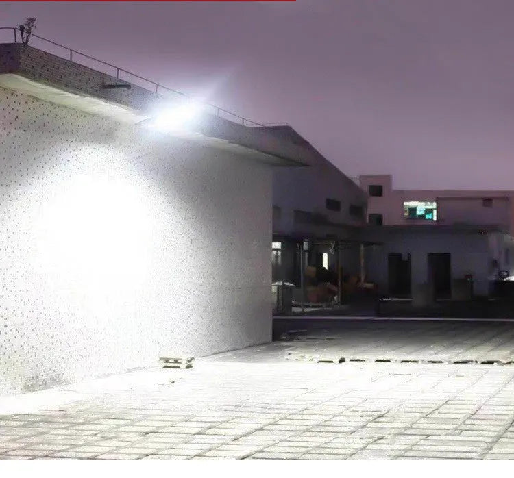 Black solar motion sensor light for outdoor garden and security lighting with PIR detection