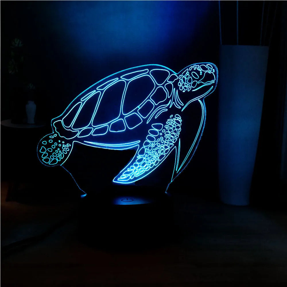 3D acrylic turtle-shaped LED night light with remote control on a table
