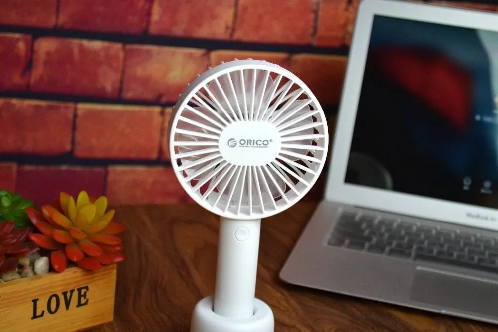 White ORICO FH1 portable USB rechargeable desk fan with three speed buttons and a compact design.