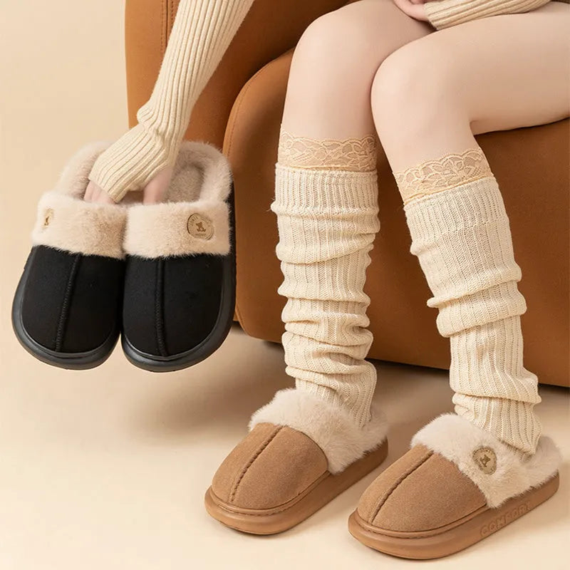 Plush fleece indoor slipper with PVC sole shown in available colours: black, blue, brown, khaki, pink.