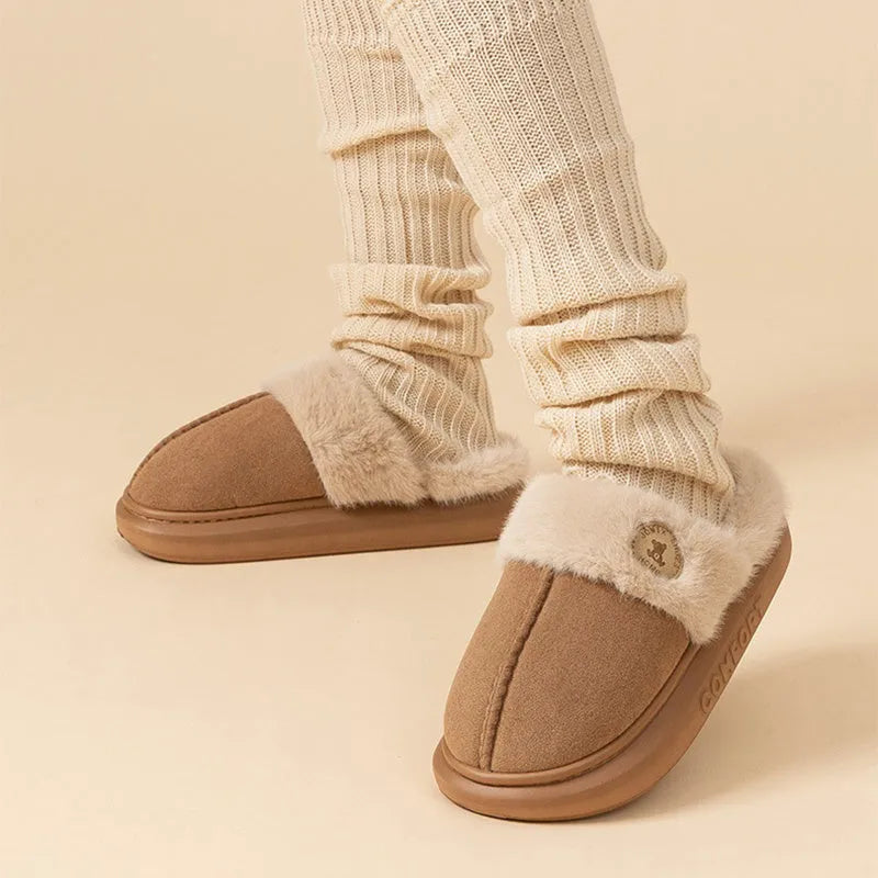 Plush fleece indoor slipper with PVC sole shown in available colours: black, blue, brown, khaki, pink.
