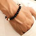 Natural stone lava bead bracelet with charms measuring 18cm in ethnic style