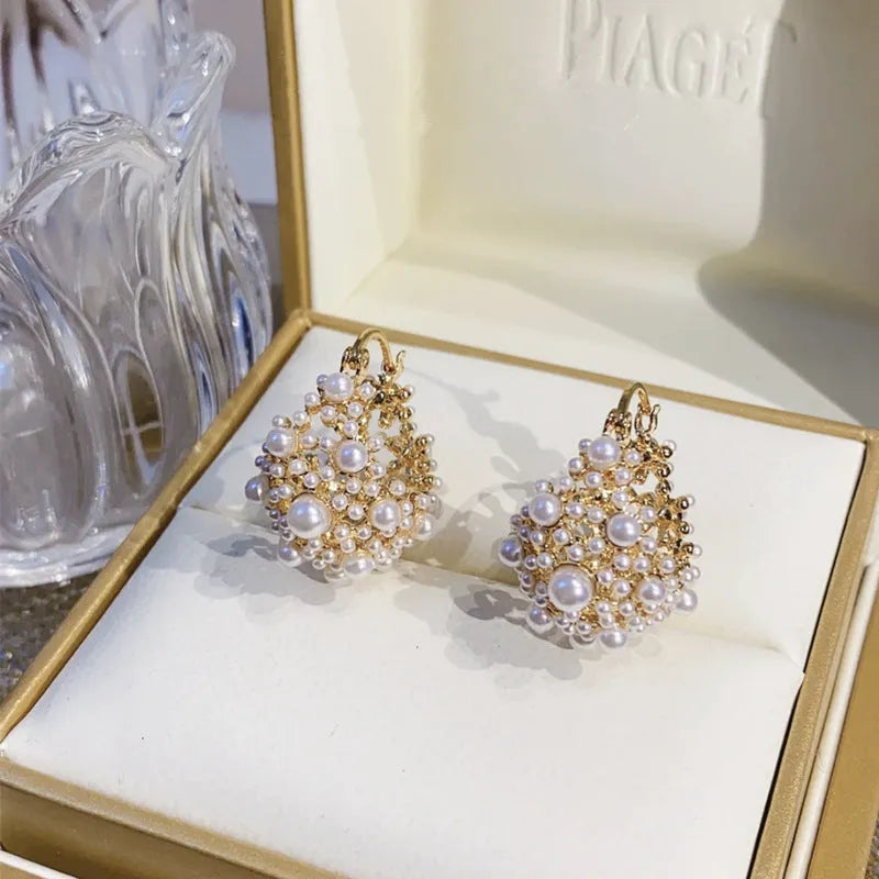 Gold copper flower basket earrings with small rice-shaped beads and pearl inlay detail