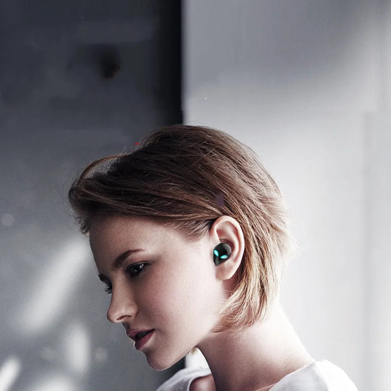 Creative Outer T8 Starman alien design Bluetooth headset with red LED lights and charging case.