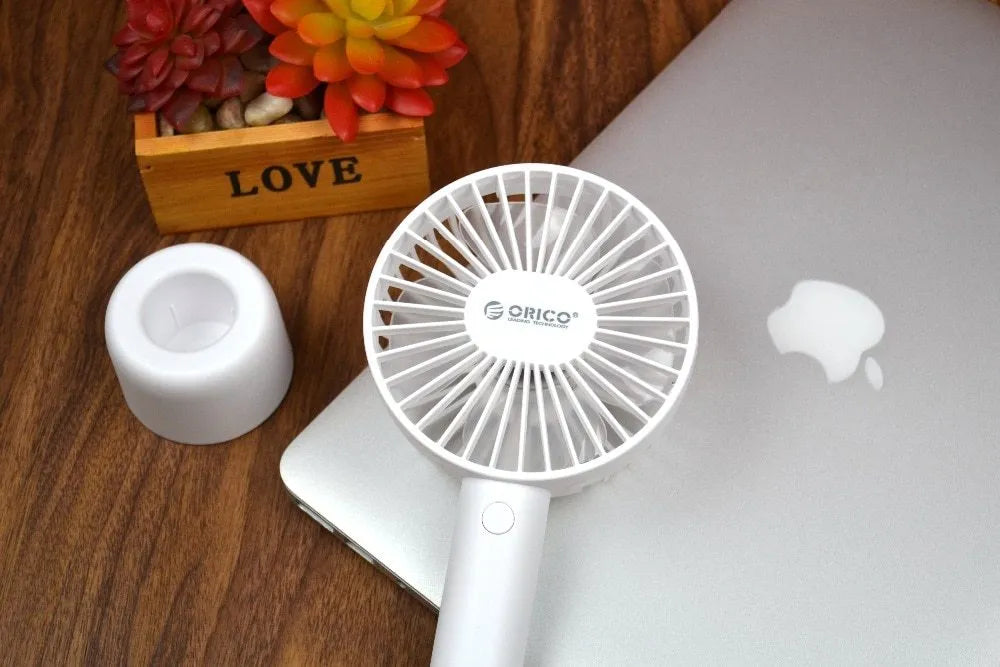 White ORICO FH1 portable USB rechargeable desk fan with three speed buttons and a compact design.