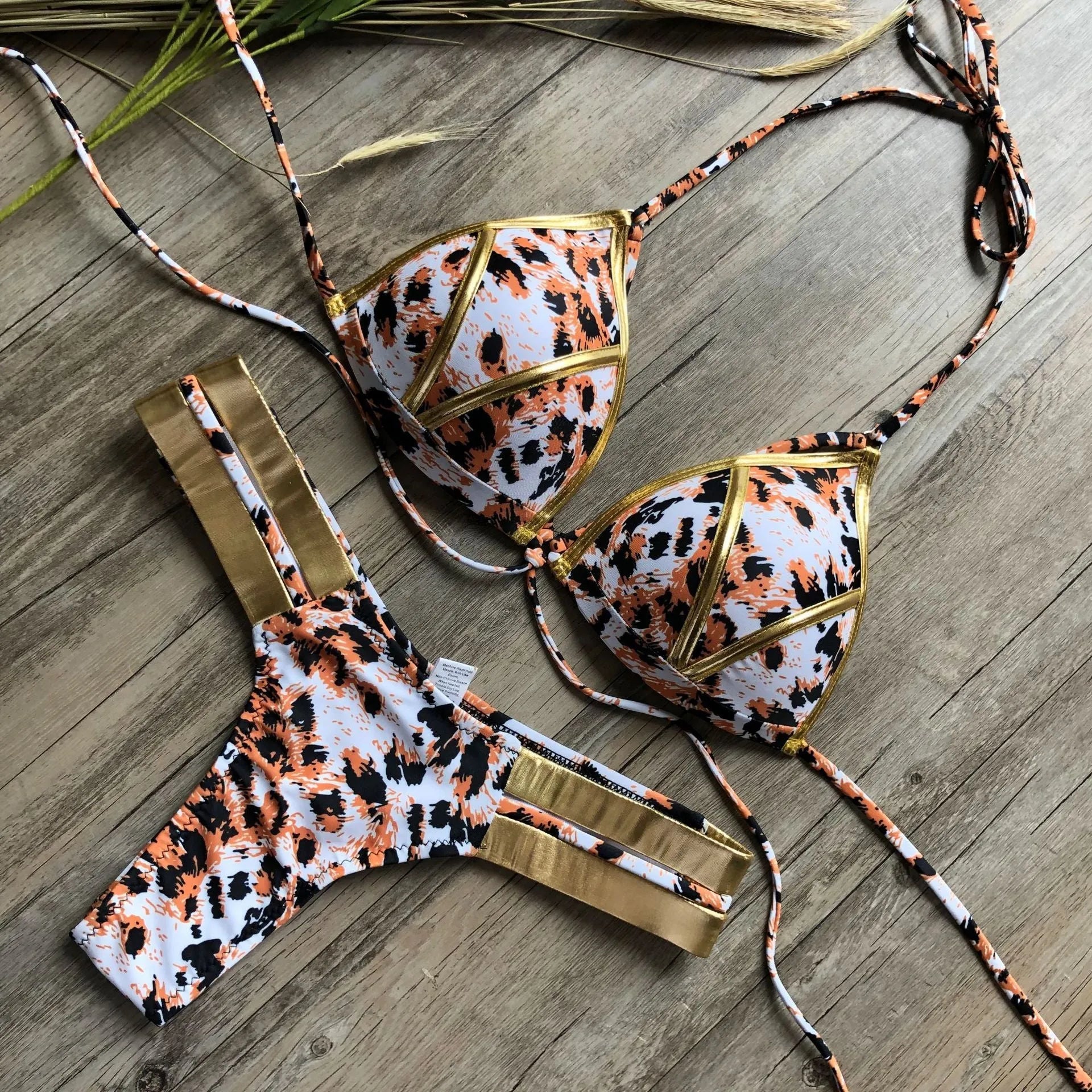Women's bronzing bikini swimsuit in nylon with chest pad, shown in multiple colour and print options.