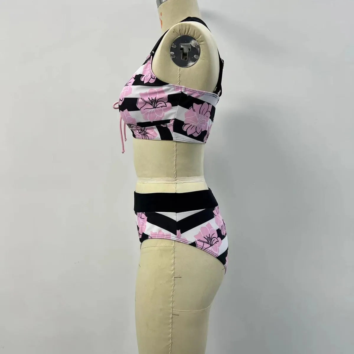 Black women's bikini with printed belly coverage and slimming split leg design.