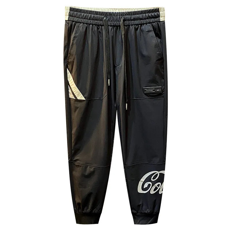 Black men's cropped trousers with banded ankle made from ice silk and cotton fabric.