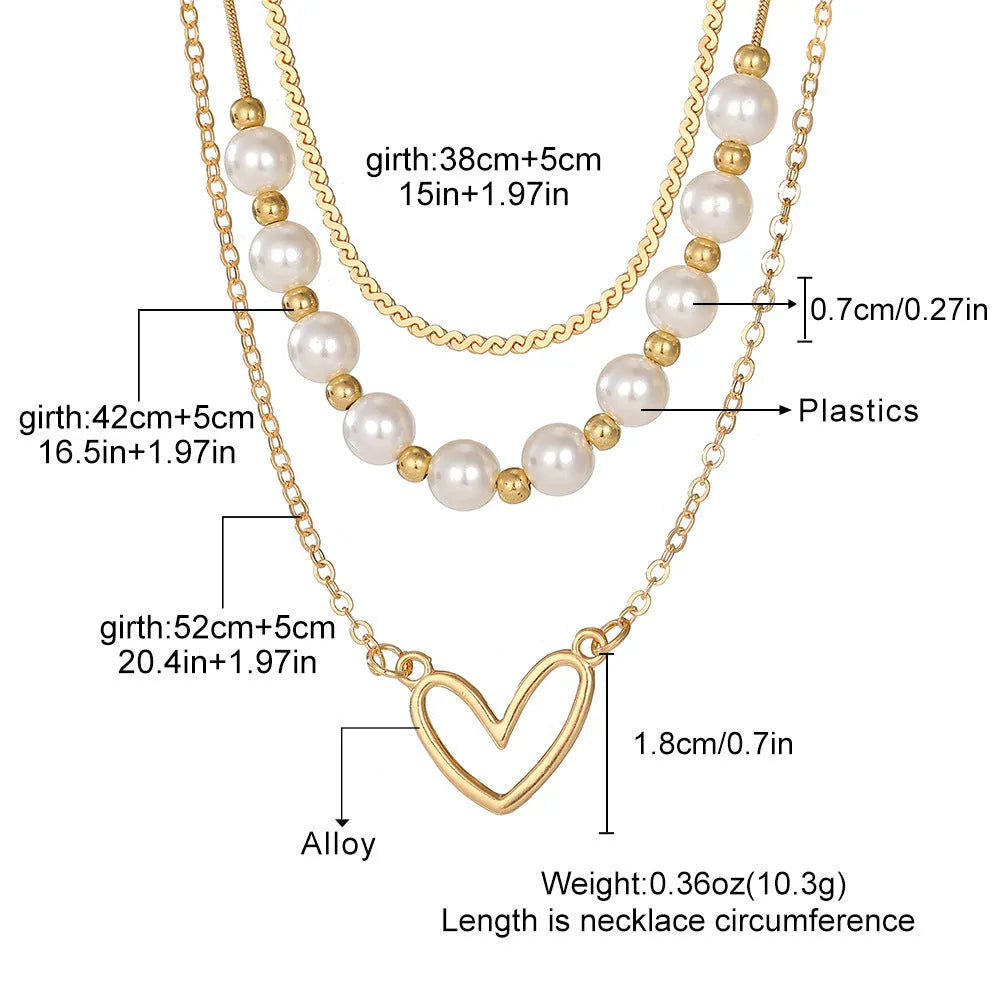 Vintage gold necklace with double heart pendant on textured pearl chain