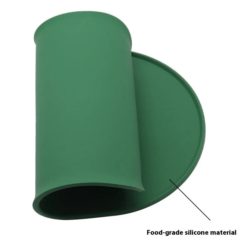 Silicone waterproof cat feeding placemat with non-slip base in beige colour on a wooden floor.
