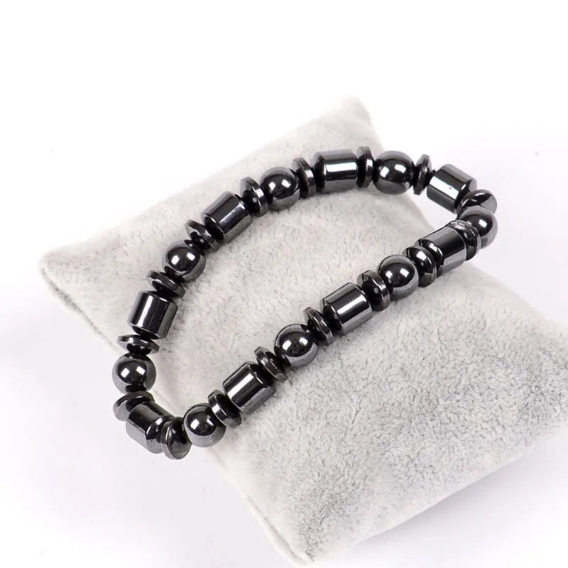 Black pentagram design magnetic therapy bracelet with magnetite and hematite stones on a stretch band.