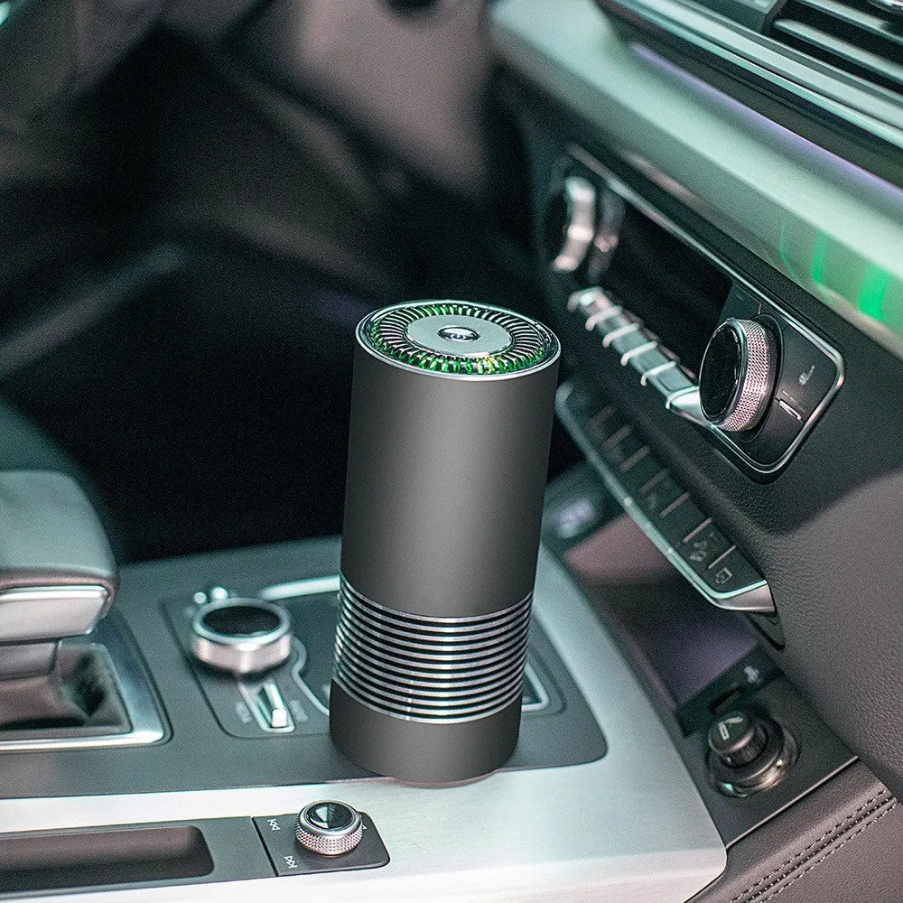 Compact metallic car air purifier on a dashboard with Black, Silver, and Grey colour options.