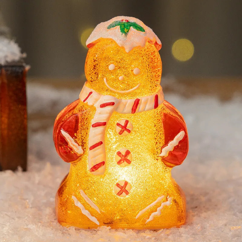 Set of four glowing plastic Christmas ornaments: gingerbread men and snowmen with red, white, and transparent scarves.
