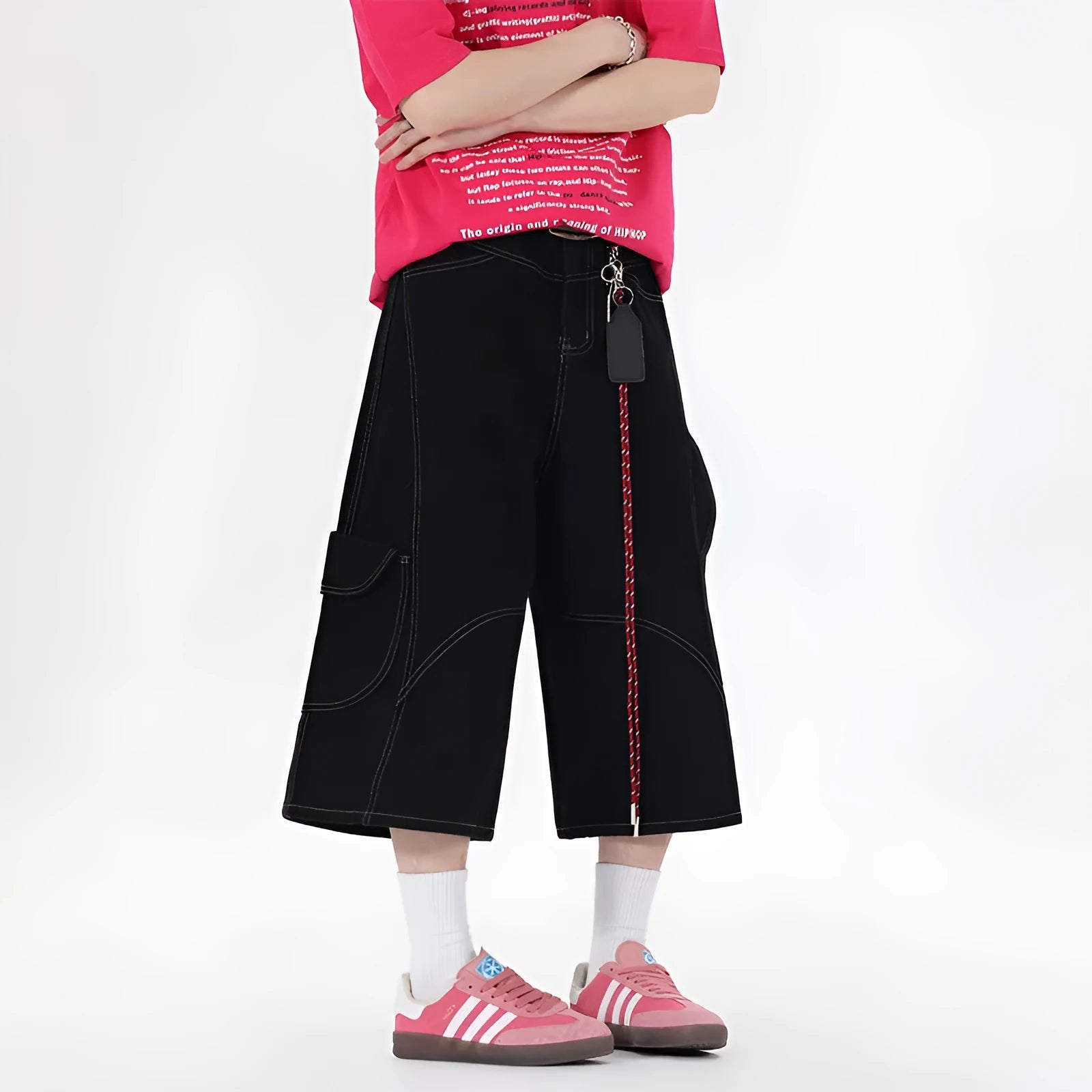 Red denim retro workwear shorts with multiple pockets and a wide-leg cropped fit on a model.