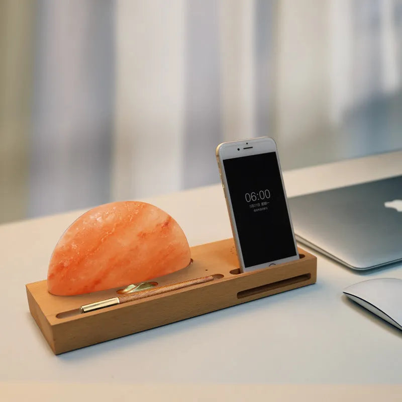 Natural crystal salt lamp on a beech wood base with integrated wireless phone charging pad.