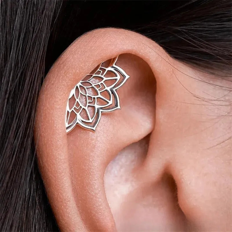 Geometric spider web design stud earrings in gold and silver electroplated metal.