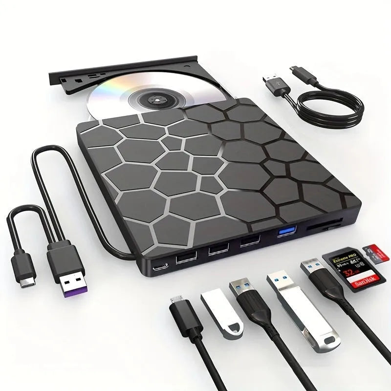 Black external USB CD/DVD drive on a desk next to a laptop
