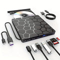 Black external USB CD/DVD drive on a desk next to a laptop
