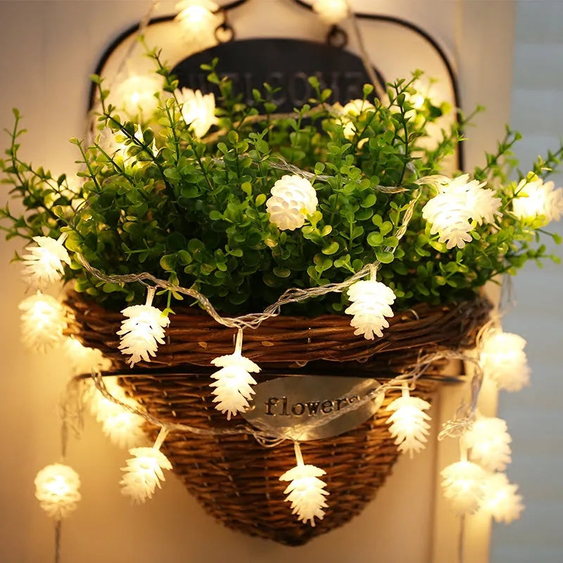 Warm white LED pine cone decorative light string powered by two AA batteries.