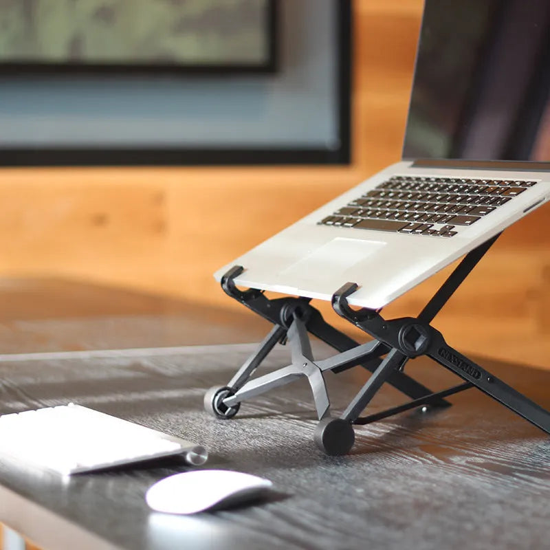 Black folding portable laptop stand made from reinforced nylon, shown in open and closed positions
