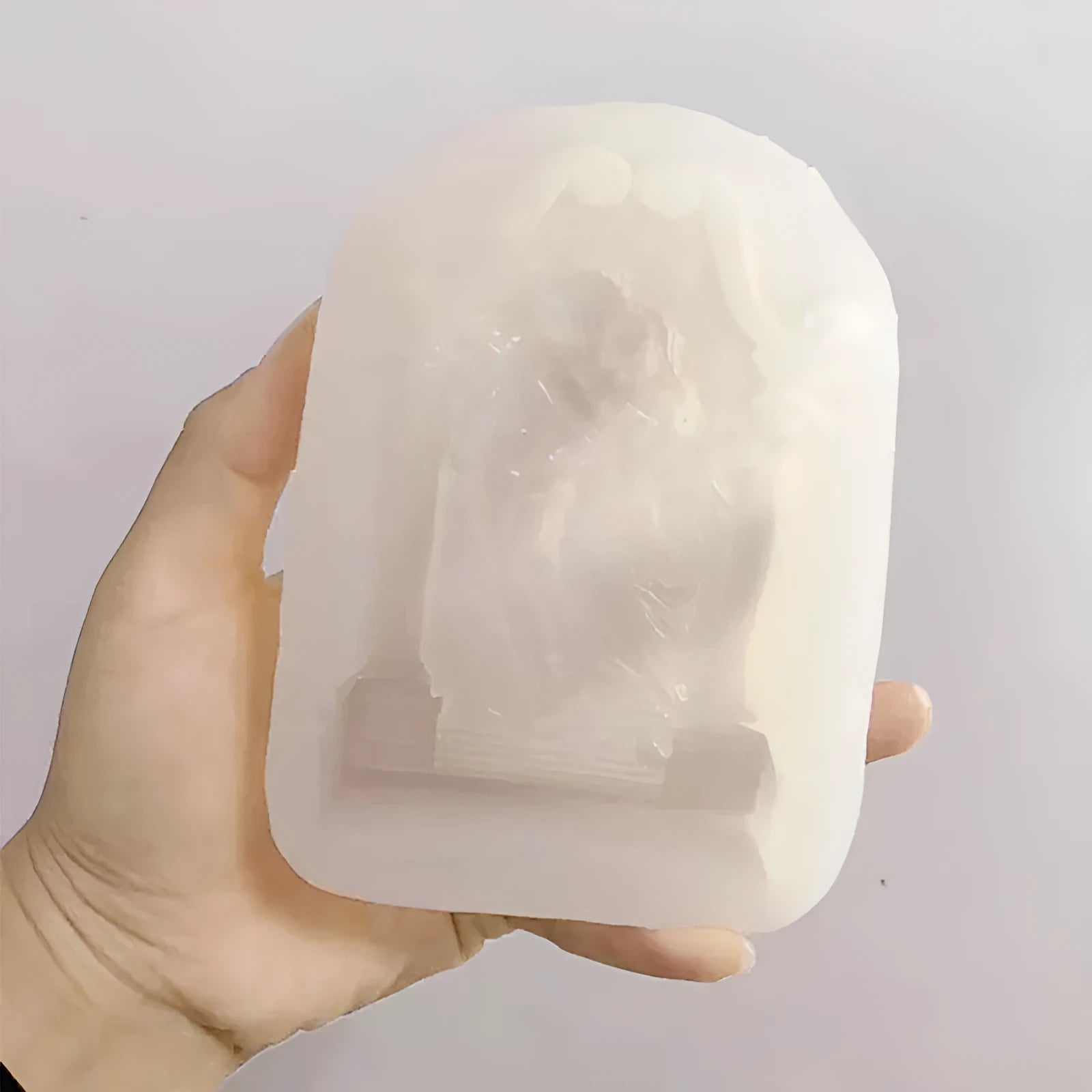 Flexible food grade silicone mold showing detailed Ancient Greek-style couple angel design for baking and crafts.