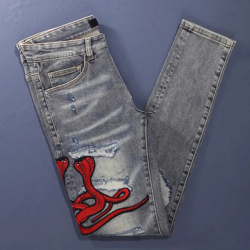 Men's washed-out slim fit jeans with patch detailing and embroidered branding on micro-elastic cotton