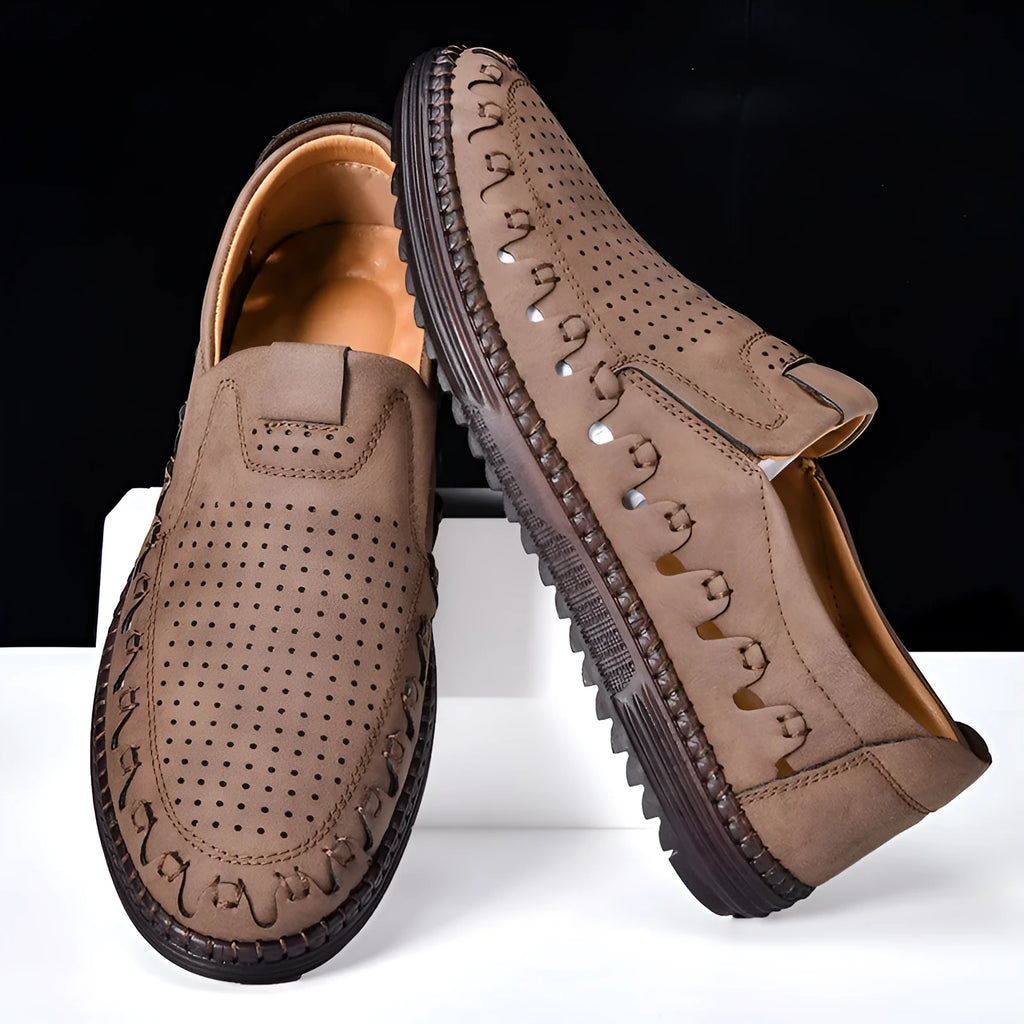 Men's brown casual slip-on leather shoes with round toe and flat sole on a white background.