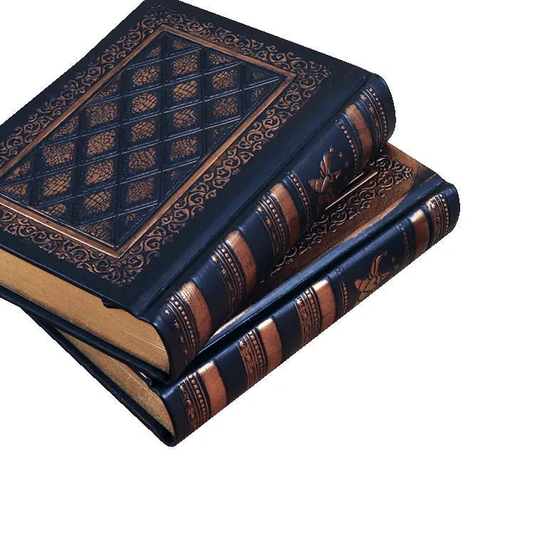 A5 hardback notebook with embossed faux leather cover in bronze colour, shown open on a table.